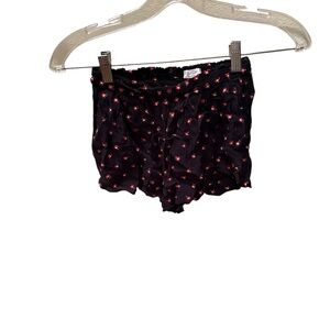 Navy blue kids shorts with red flowers all over them